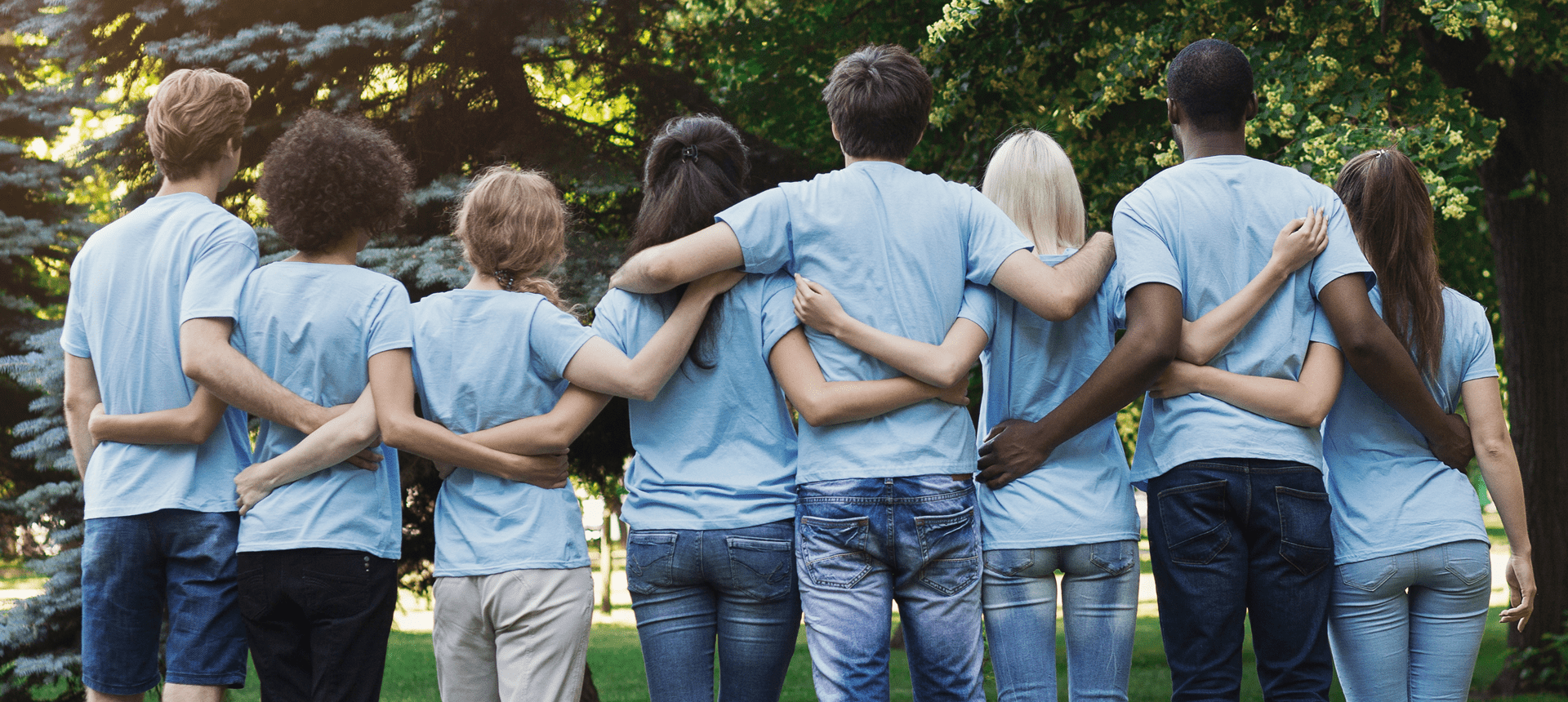 Group of friends hugging outdoors