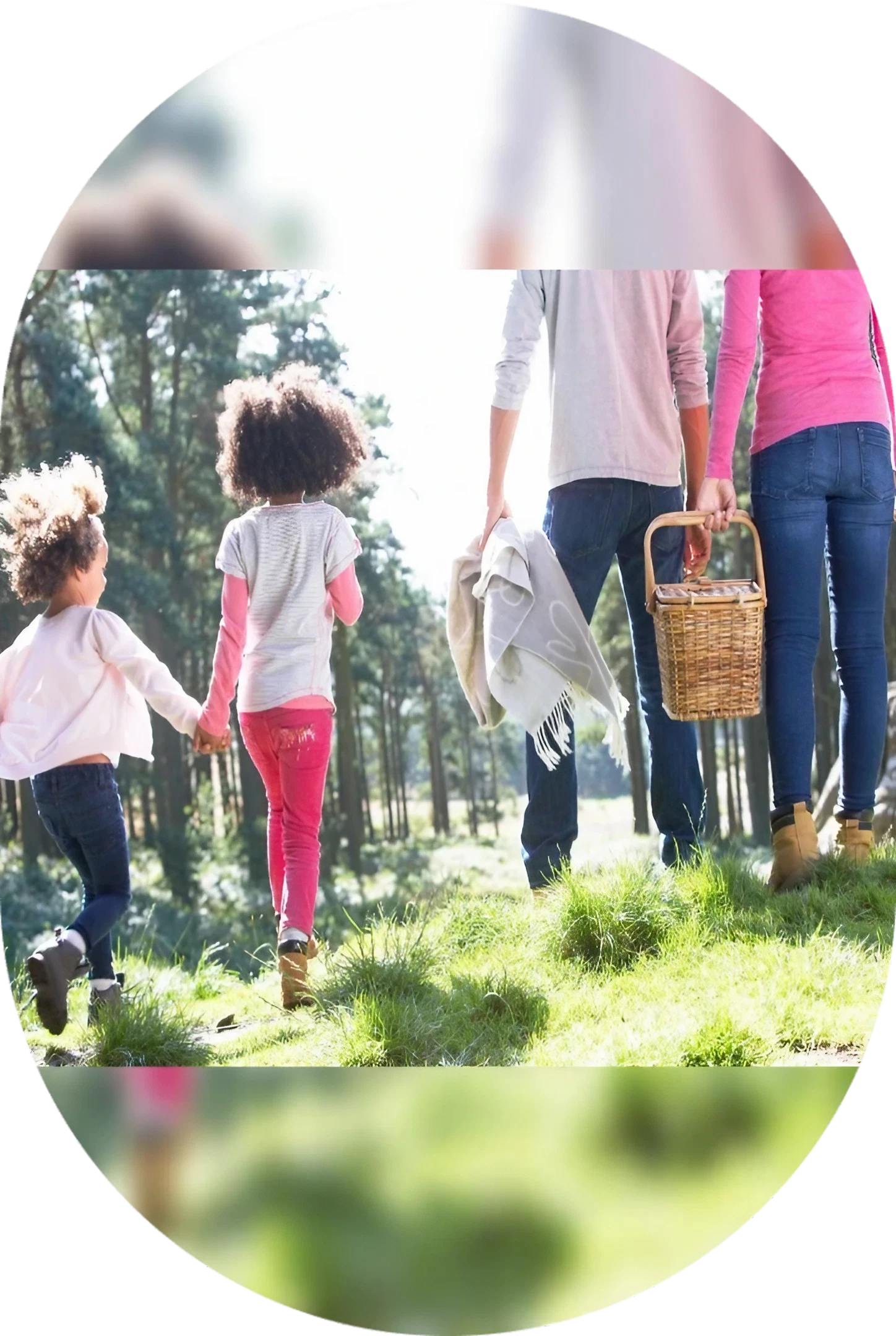 Family walking together outdoors on a sunny day.